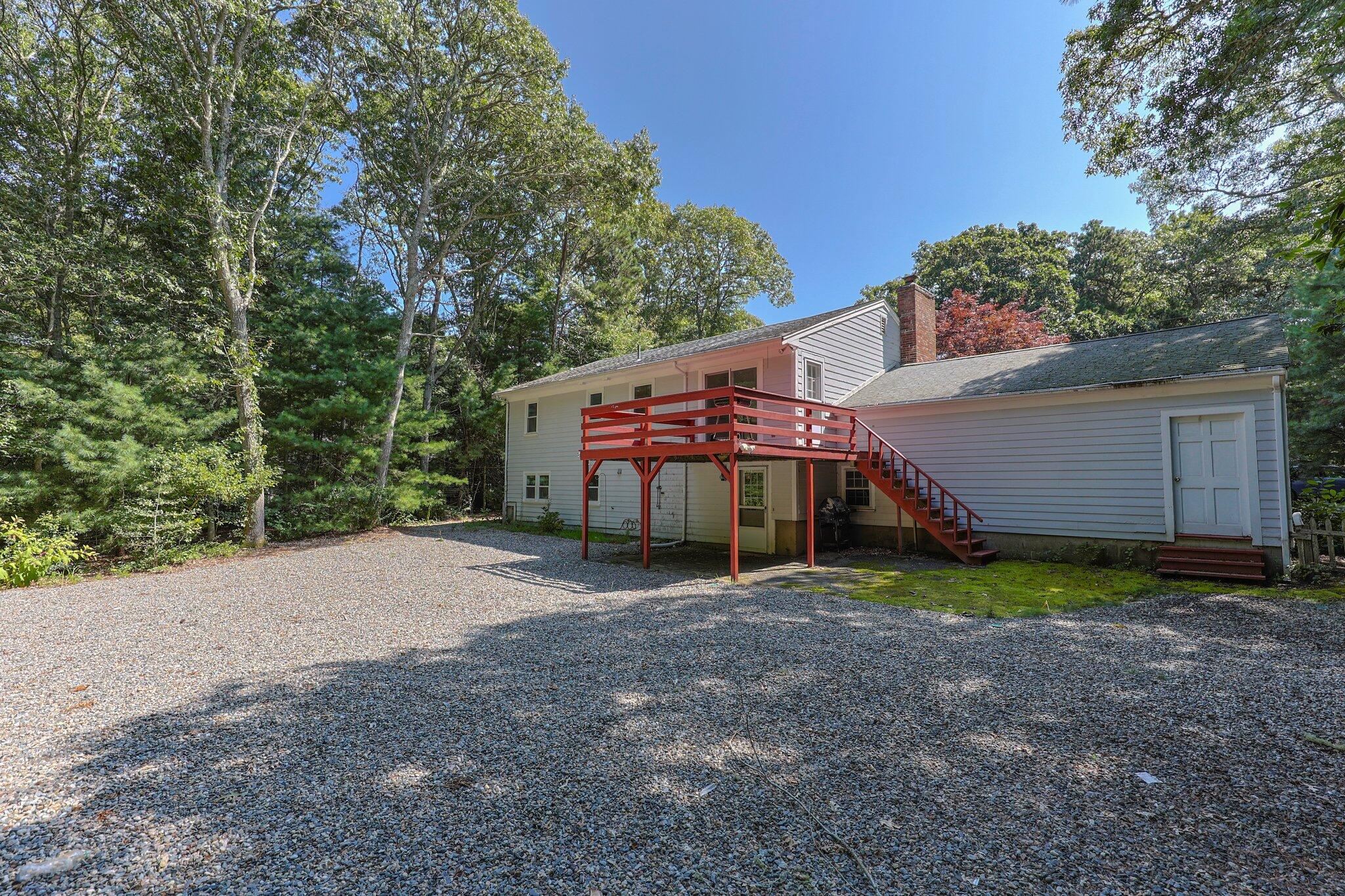 87 Fuller Road Centerville, MA 02632 - Photo 31 of 33 a view of a house with a yard and garage
