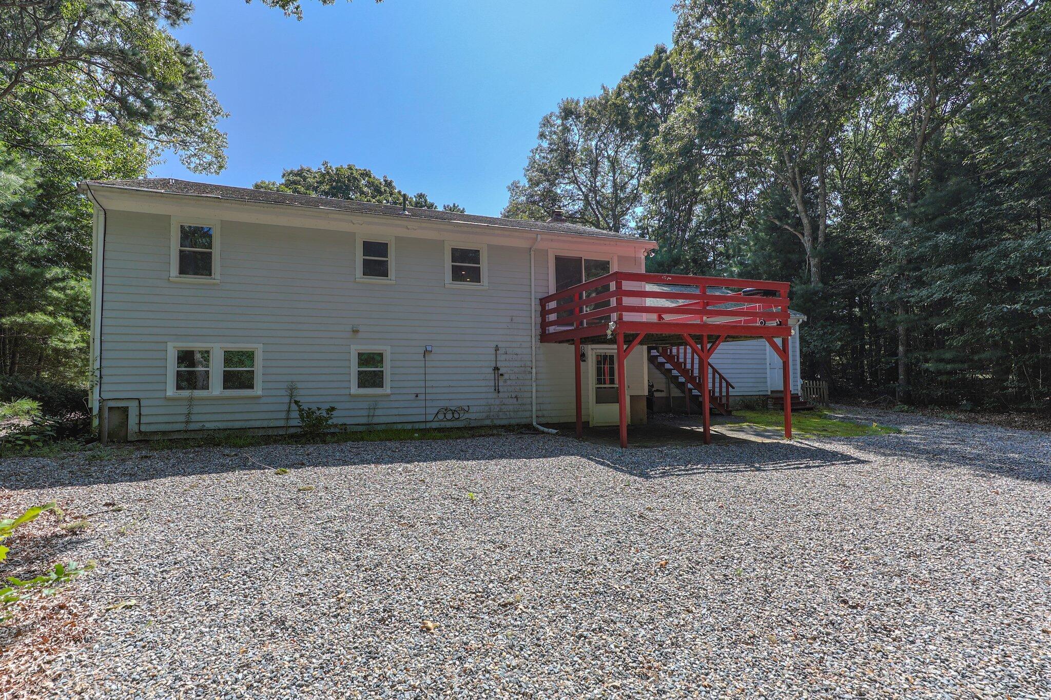 87 Fuller Road Centerville, MA 02632 - Photo 32 of 33 a backyard of a house with barbeque oven fire pit table and chairs