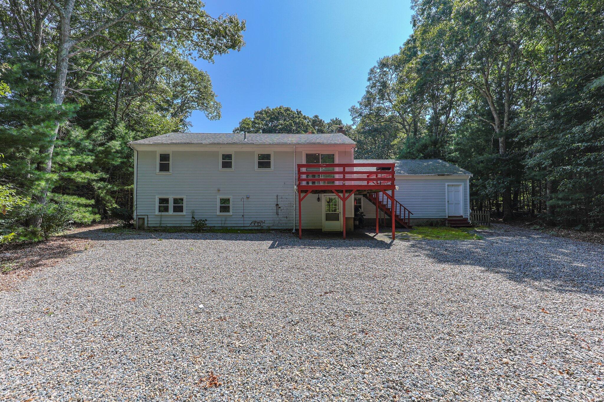 87 Fuller Road Centerville, MA 02632 - Photo 33 of 33 a view of a house with a yard and plants