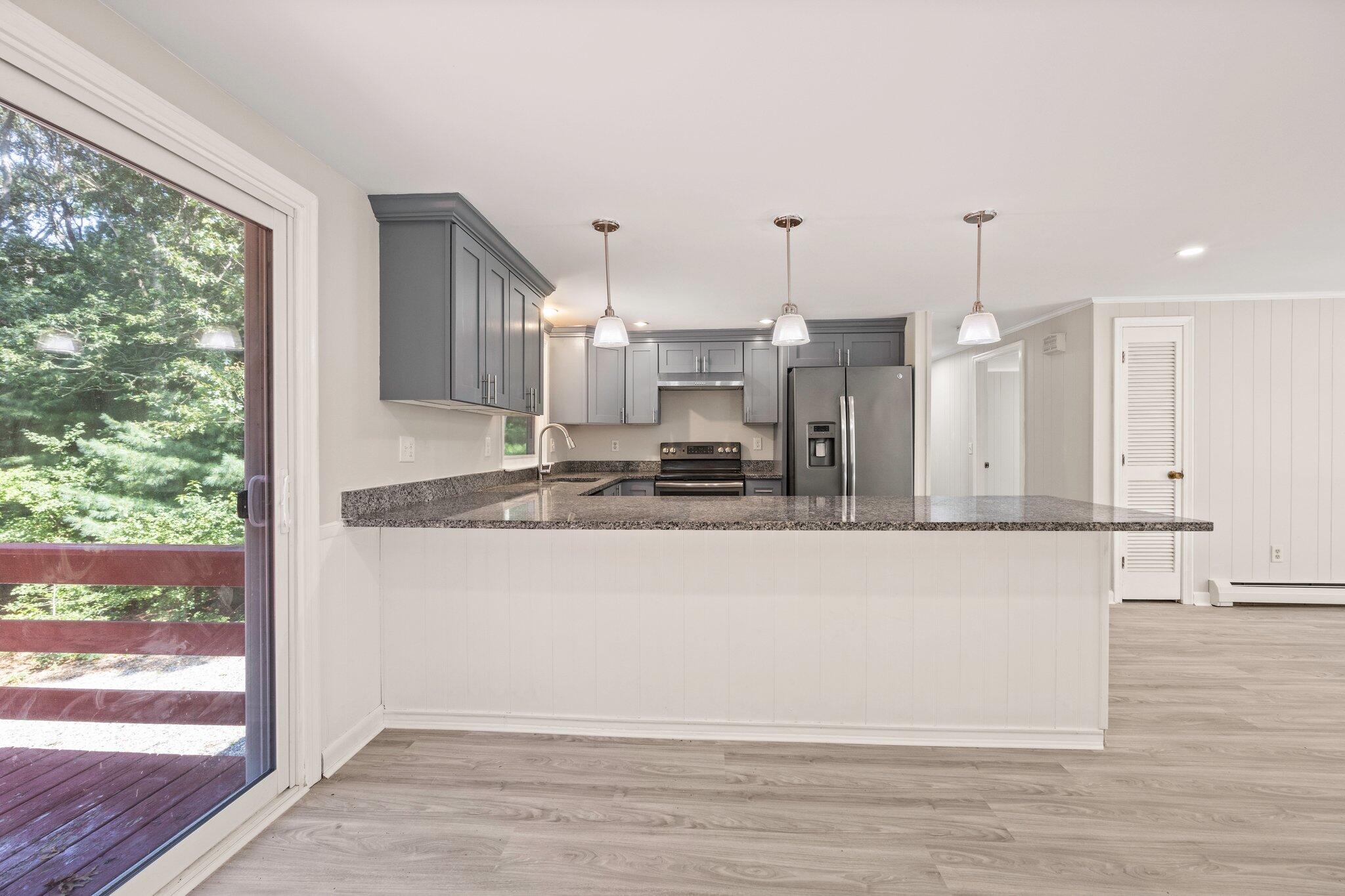 87 Fuller Road Centerville, MA 02632 - Photo 7 of 33 a view of a kitchen with wooden floor
