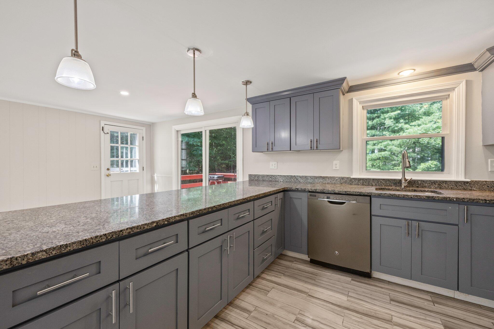 87 Fuller Road Centerville, MA 02632 - Photo 10 of 33 a kitchen with granite countertop wooden cabinets a sink a window and appliances