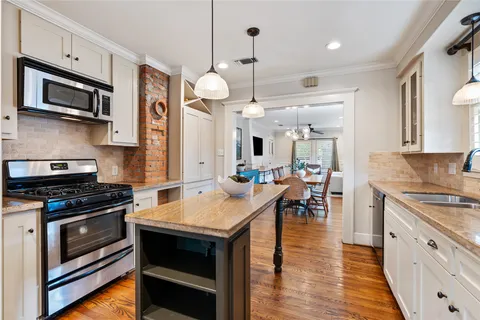 a kitchen with stainless steel appliances granite countertop a refrigerator and a stove