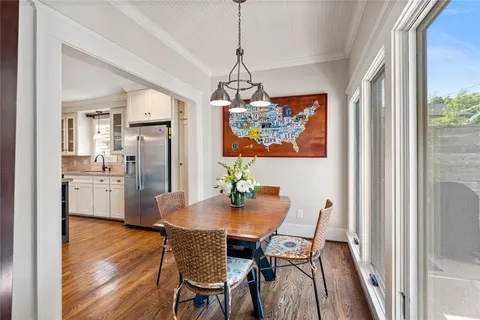 a living room with kitchen island granite countertop furniture and a chandelier