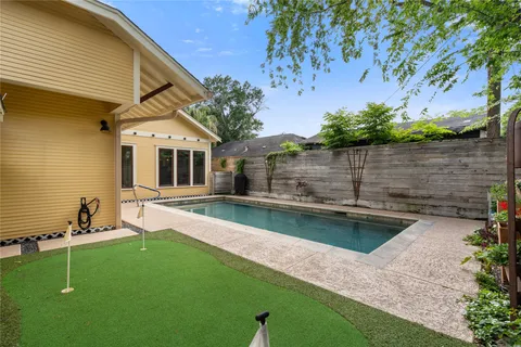 a view of a backyard with a large pool and sitting area