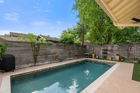 a view of a patio with a dining table and chairs