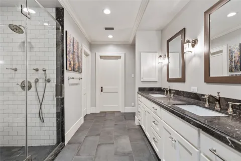 a spacious bathroom with a granite countertop sink mirror and shower