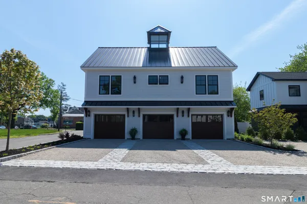 a view of a house with a yard and garage