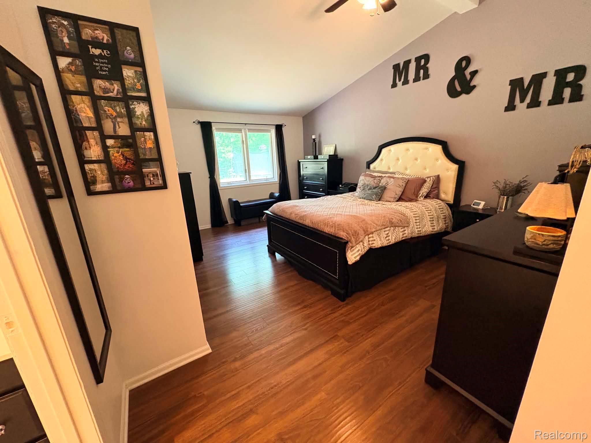 2159 East Bevens Road Caro, MI 48723 - Photo 21 of 38 Spacious room featuring wood-finish flooring, a vaulted ceiling, and a large window