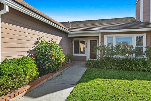 a front view of a house with garden