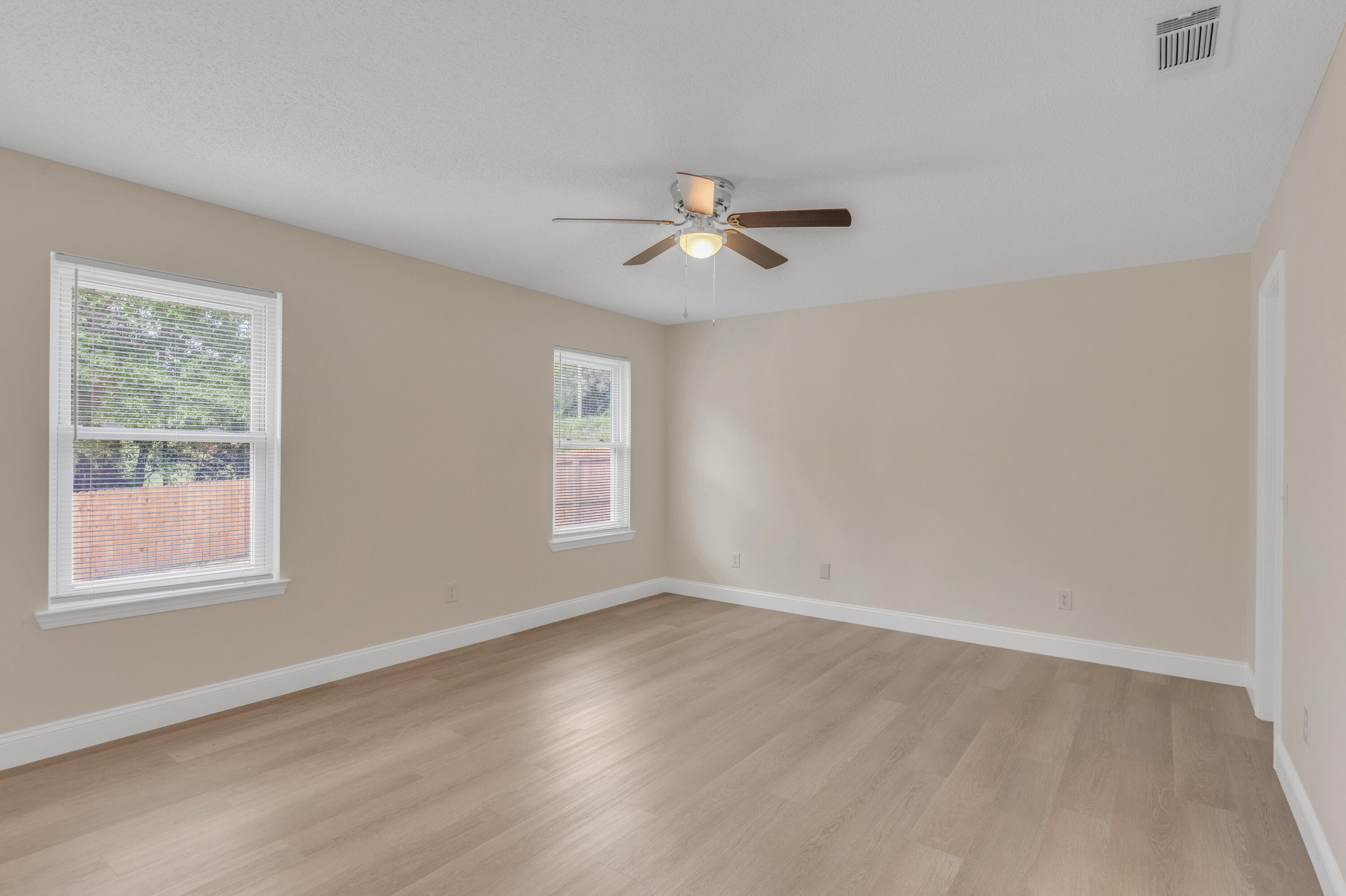 203 Riverchase Boulevard Crestview, FL 32536 - Photo 15 of 36 a view of empty room with wooden floor and fan