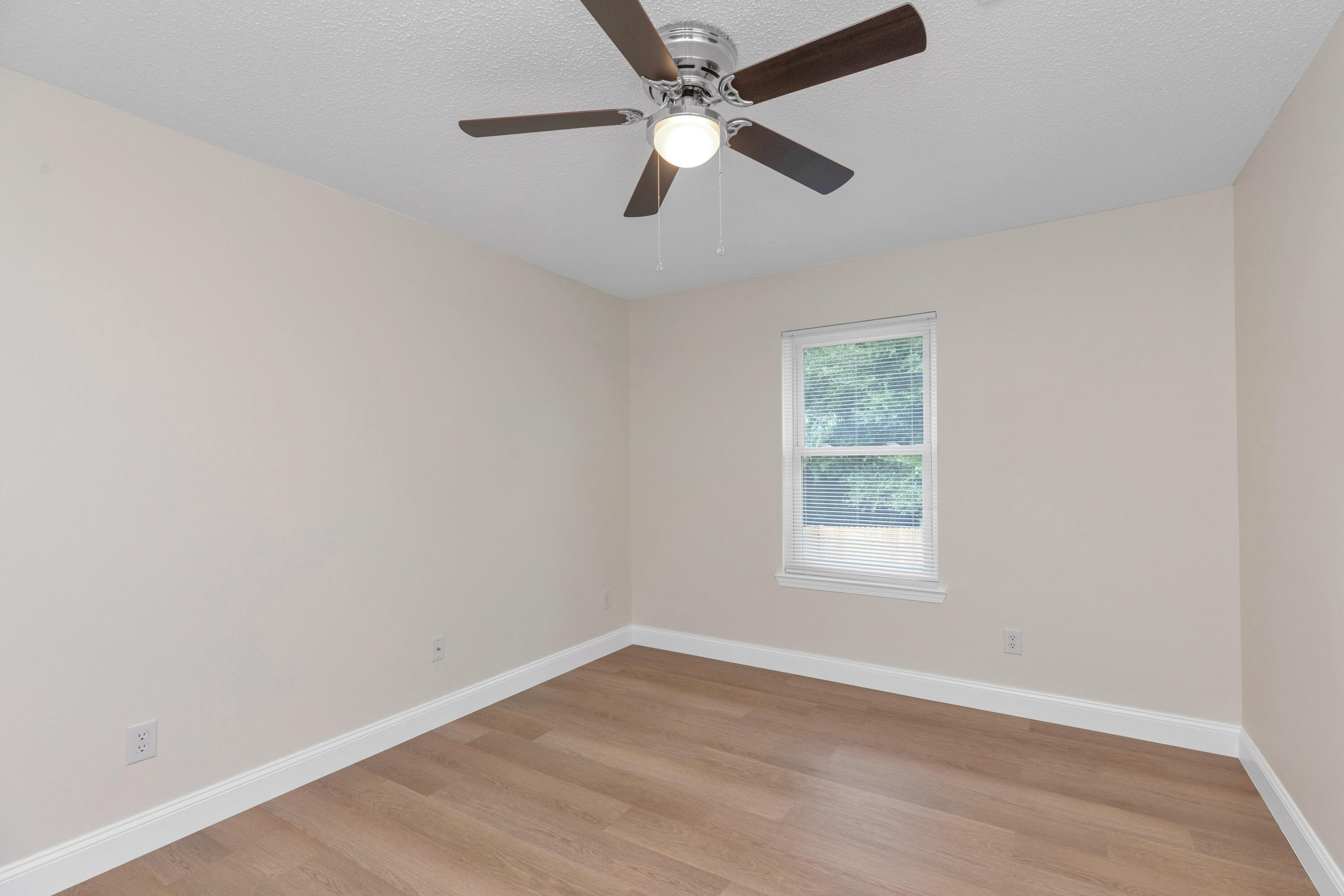 203 Riverchase Boulevard Crestview, FL 32536 - Photo 21 of 36 an empty room with a window and a fan