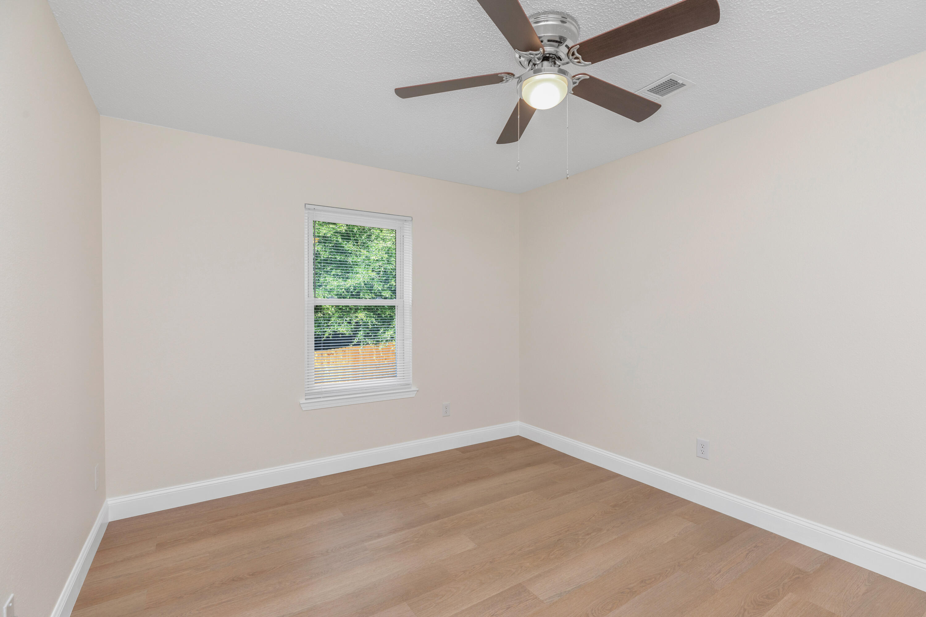 203 Riverchase Boulevard Crestview, FL 32536 - Photo 22 of 36 an empty room with a window and a fan