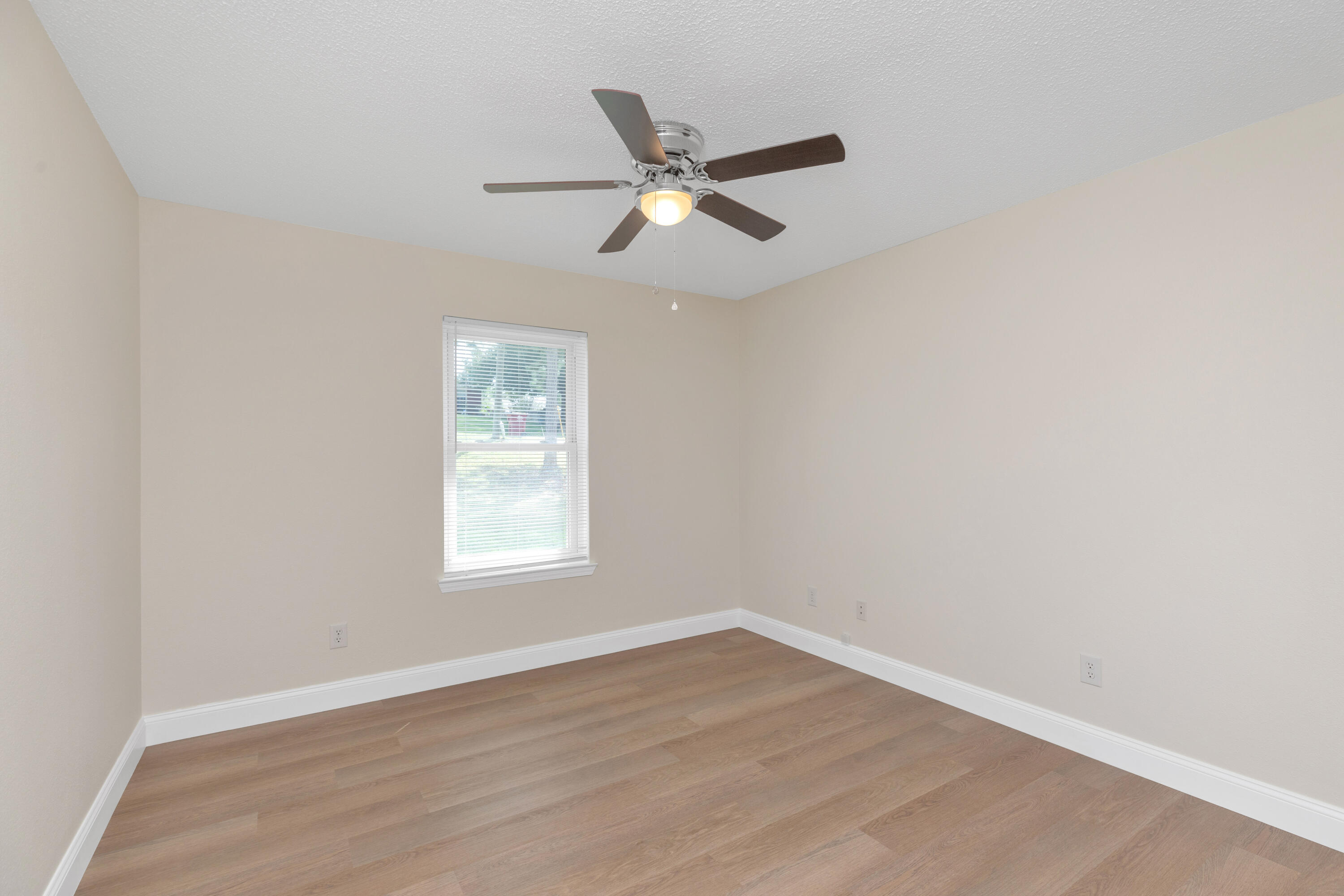 203 Riverchase Boulevard Crestview, FL 32536 - Photo 27 of 36 a view of an empty room with wooden floor and a window