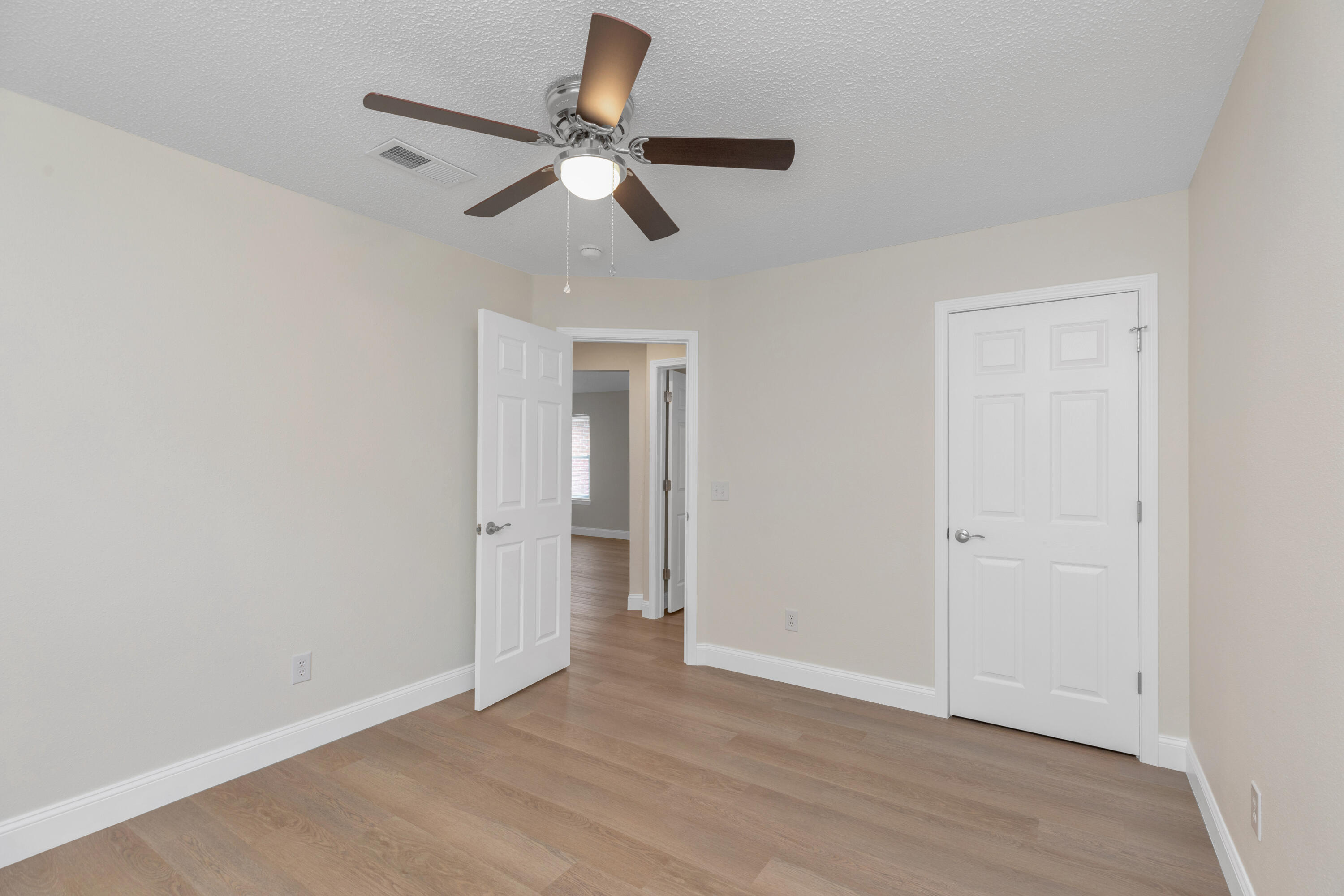 203 Riverchase Boulevard Crestview, FL 32536 - Photo 29 of 36 a view of an empty room with wooden floor