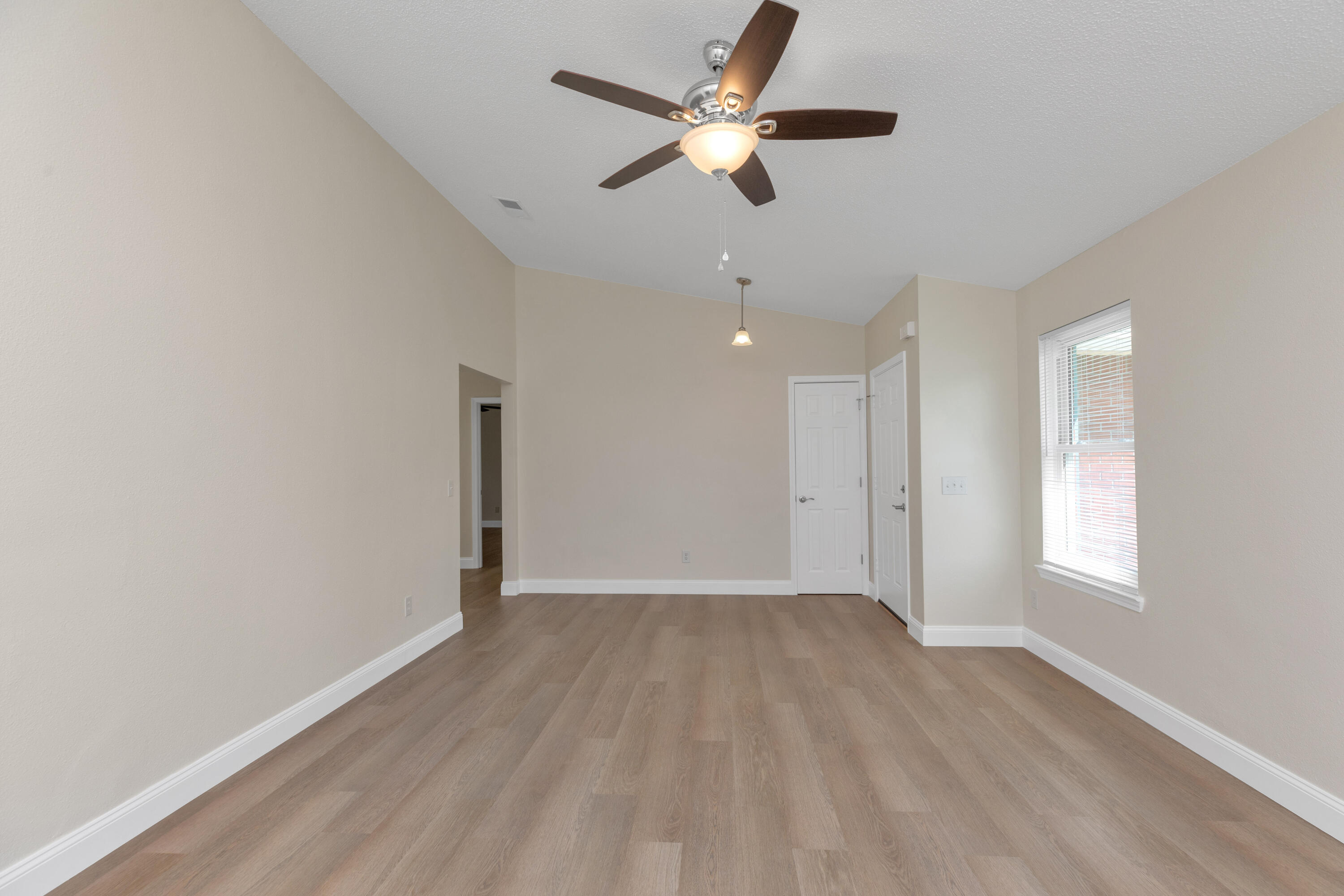 203 Riverchase Boulevard Crestview, FL 32536 - Photo 6 of 36 wooden floor in an empty room with a window