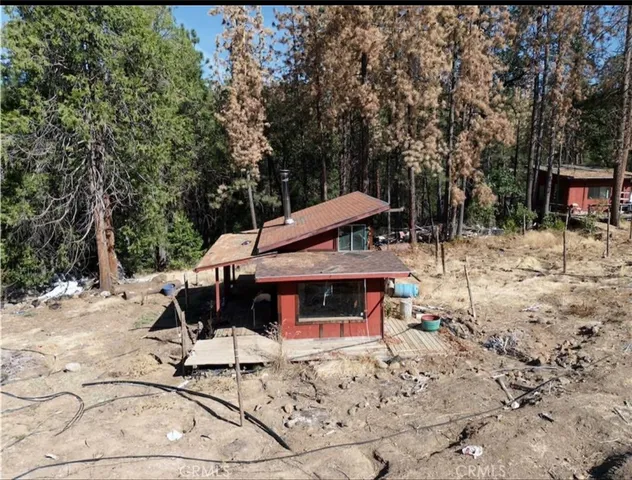 a view of a patio with a table and chairs under an umbrella