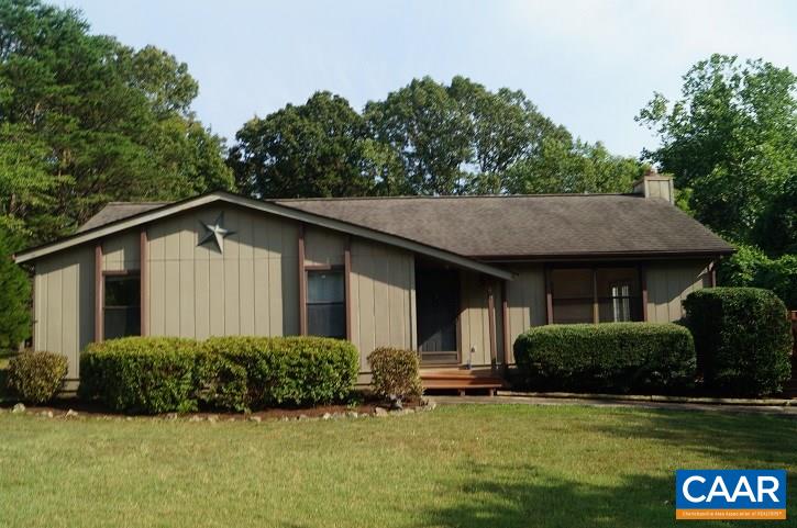 a view of a house with pool and a yard