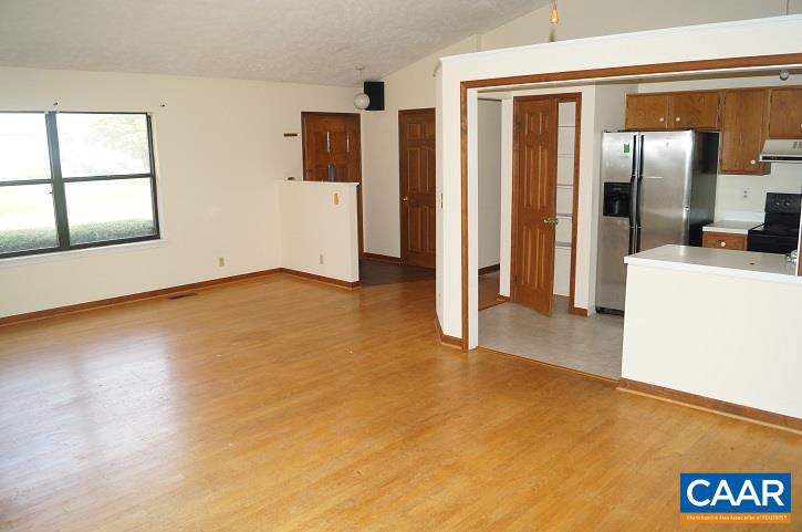 84 Wedgestone Road Stanardsville, VA 22973 - Photo 16 of 34 a view of a kitchen with a sink refrigerator and wooden floor