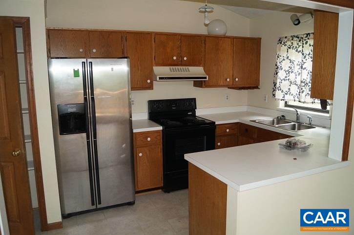 84 Wedgestone Road Stanardsville, VA 22973 - Photo 21 of 34 a kitchen with a sink a refrigerator and cabinets