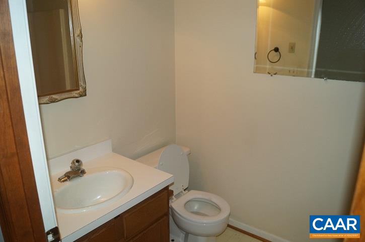 84 Wedgestone Road Stanardsville, VA 22973 - Photo 34 of 34 a bathroom with a sink a toilet and mirror