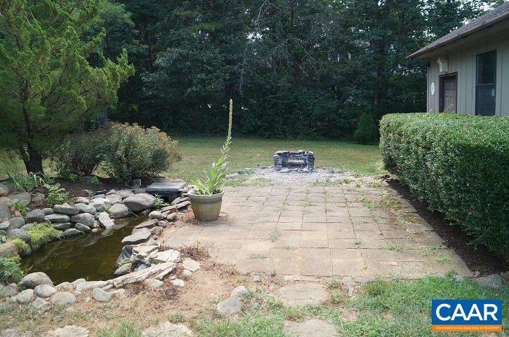 84 Wedgestone Road Stanardsville, VA 22973 - Photo 10 of 34 a view of backyard with outdoor seating and green space