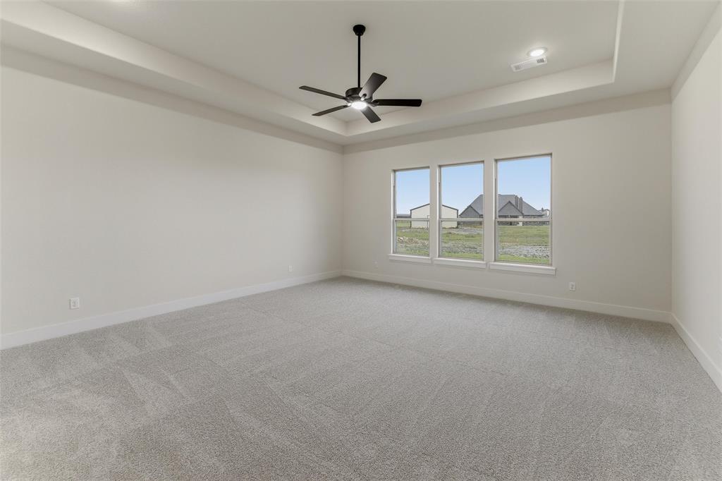 2208 Continent Court Krum, TX 76249 - Photo 18 of 26 Spacious room featuring gray carpeting and white walls