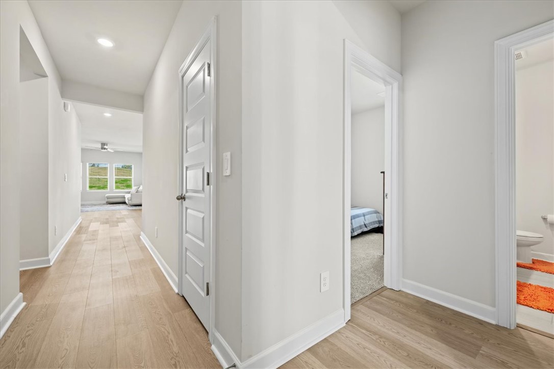 106 Purcell Way Easley, SC 29642 - Photo 27 of 39 This bright hallway connects to sunlit living spaces and private rooms.