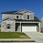 a view of a house with a yard and garage