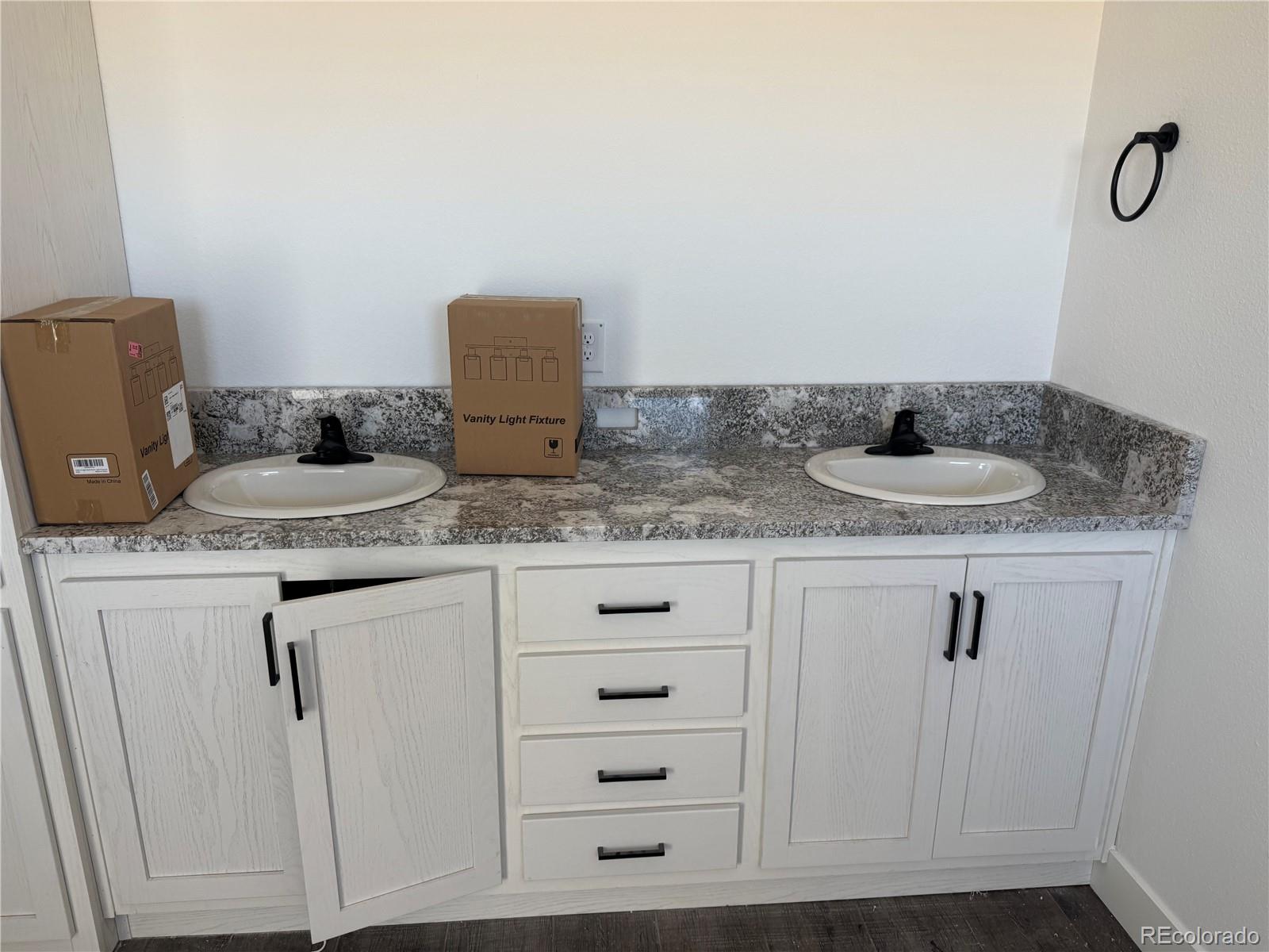 5117 Pass Me By Road Strasburg, CO 80136 - Photo 12 of 19 a bathroom with a granite countertop sink and a mirror
