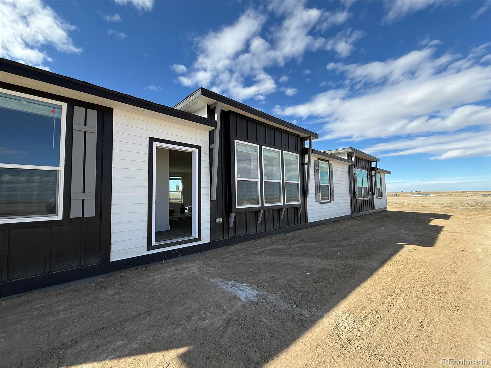 5117 Pass Me By Road Strasburg, CO 80136 - Photo 15 of 19 a view of backyard with large tree