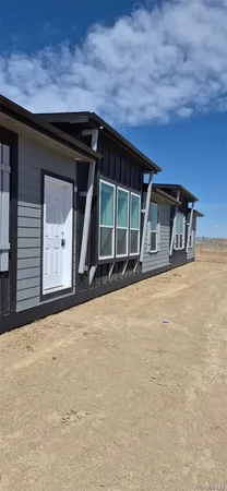 a front view of a house with large windows