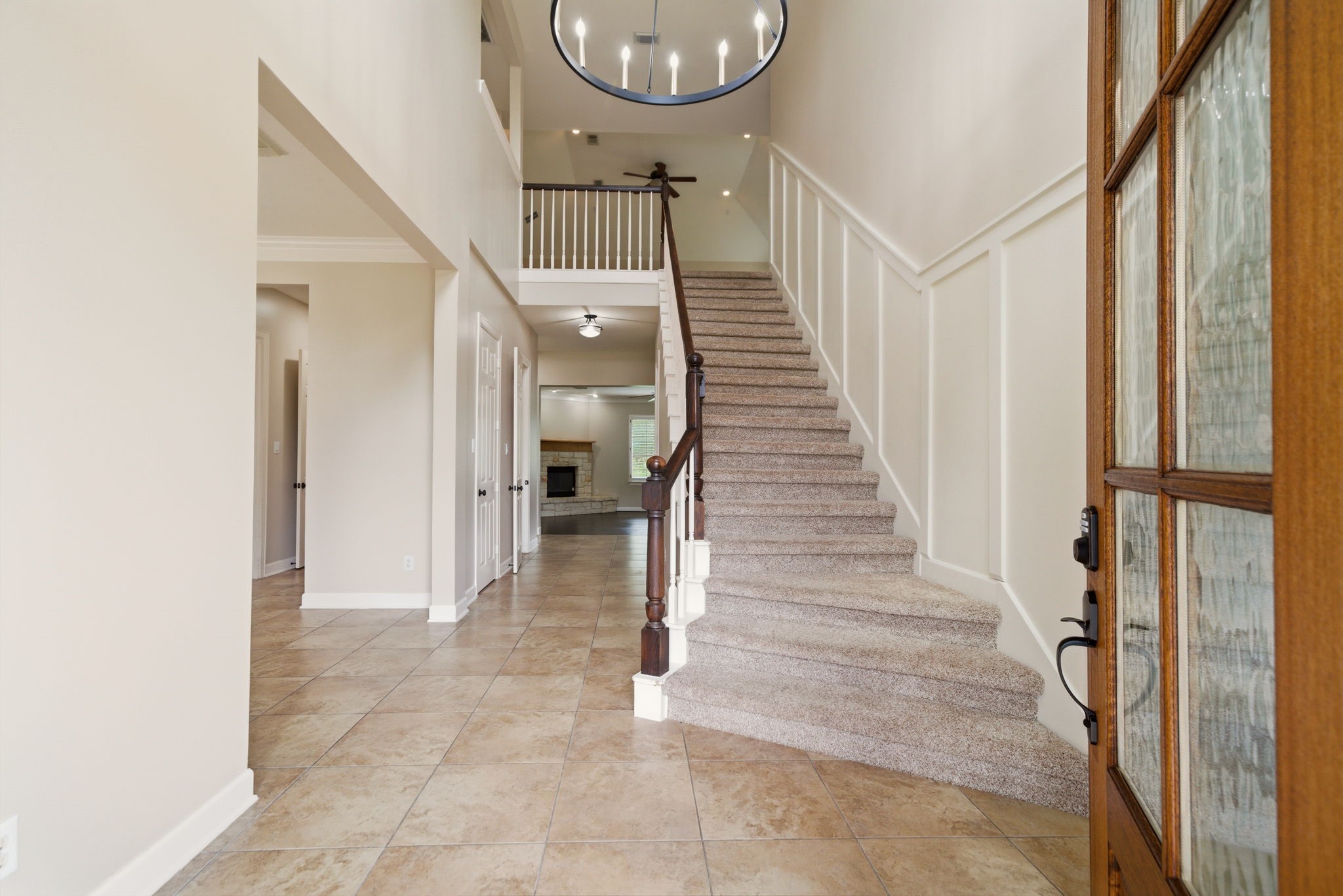 4535 Box Turtle Lane Fulshear, TX 77441 - Photo 11 of 49 Welcome home to a stunning entryway featuring elegant tile flooring, a grand staircase, and a glimpse of the inviting living area, perfect for your next chapter.