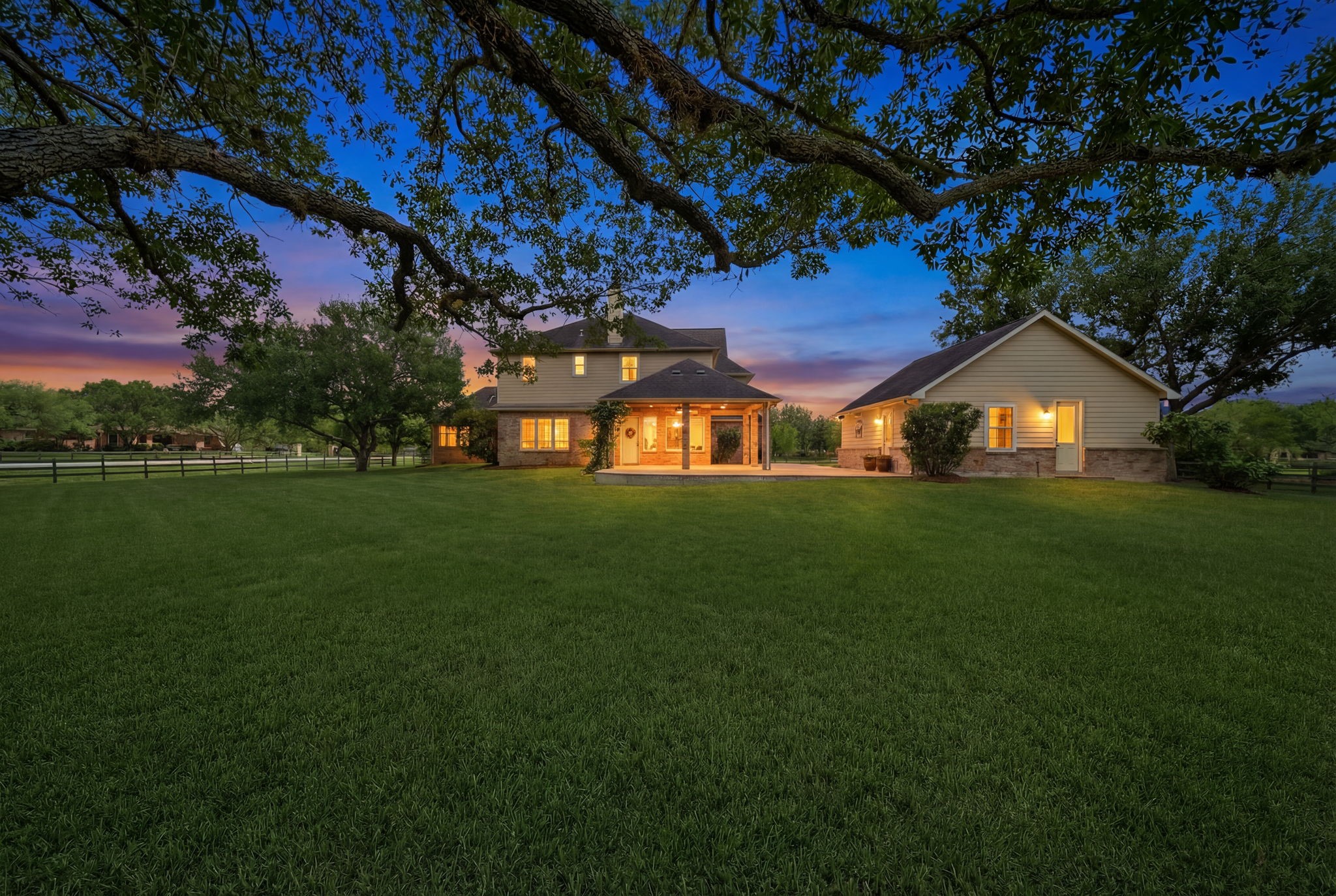 4535 Box Turtle Lane Fulshear, TX 77441 - Photo 2 of 49 Enjoy a spacious backyard shaded by mature oak trees, offering a peaceful, park-like setting perfect for relaxing, entertaining, or enjoying the outdoors in comfort.