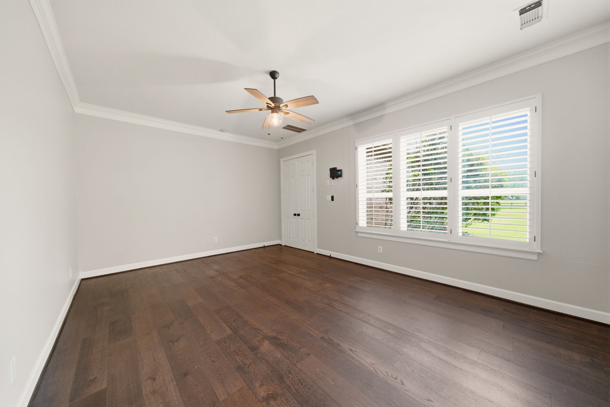 4535 Box Turtle Lane Fulshear, TX 77441 - Photo 26 of 49 Large windows with shutters offer plenty of natural light, and the room has a clean, modern feel.