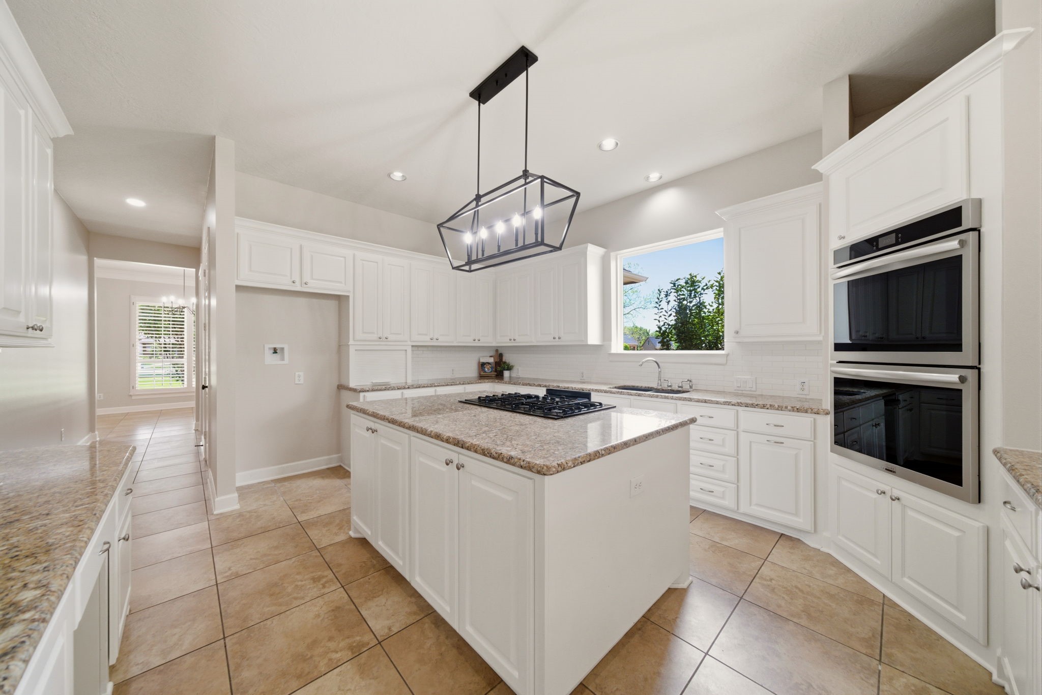 4535 Box Turtle Lane Fulshear, TX 77441 - Photo 3 of 49 Bright and open chef’s kitchen featuring granite countertops, stainless steel appliances, gas cooking, and abundant storage with generous counter space