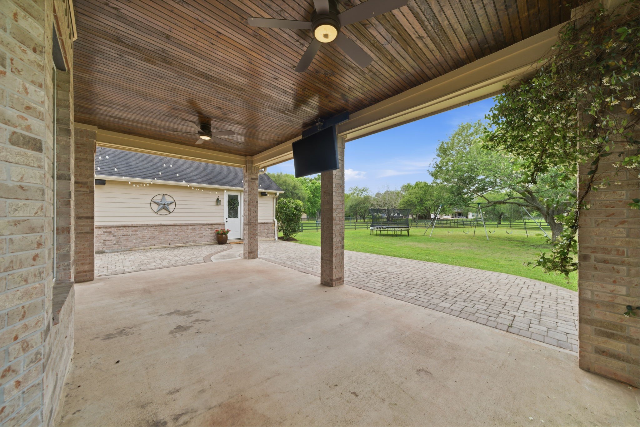 4535 Box Turtle Lane Fulshear, TX 77441 - Photo 5 of 49 This property features a covered patio perfect for outdoor relaxation and entertainment all while overlooking a spacious, well-maintained yard. The patio has been extended with pavers for easy access to detached flex space and workshop.