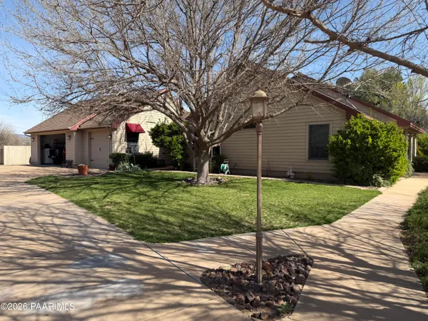 a house with green field in front of it