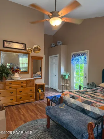 a bed room with a bed mirror and a window