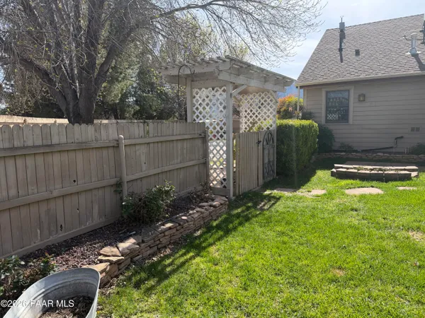 a backyard of a house with a yard and outdoor seating