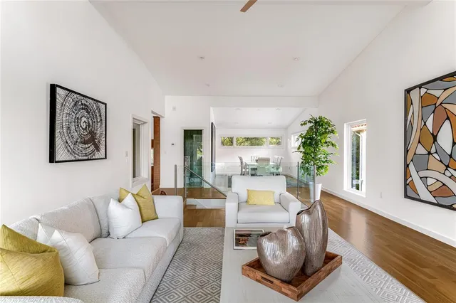 a living room with furniture a fireplace and a large window