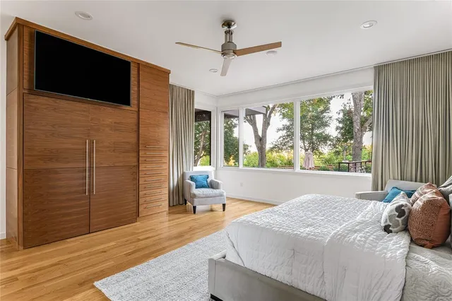 a bedroom with a large bed and a window