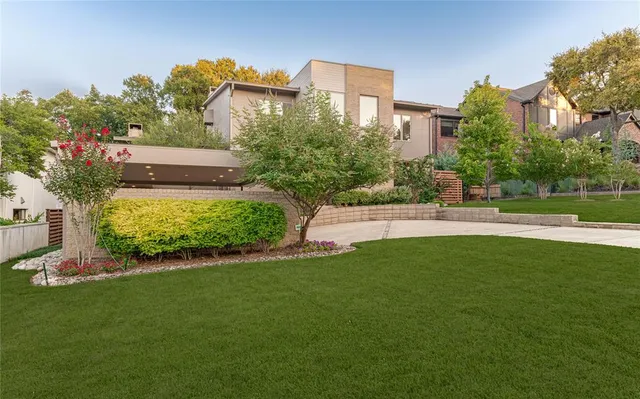 a view of a house with a garden and a yard