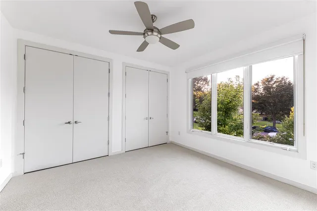 an empty room with windows and closet