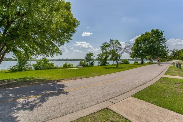 a view of a house with a big yard and potted plants