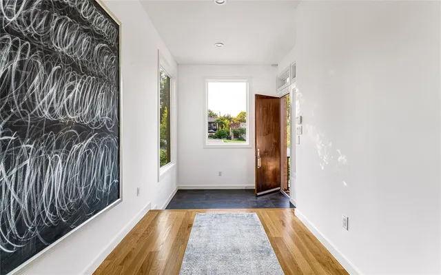 a view of hallway with wooden floor
