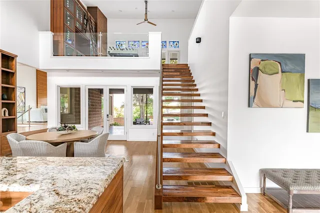 a view of a hallway with wooden floor and windows