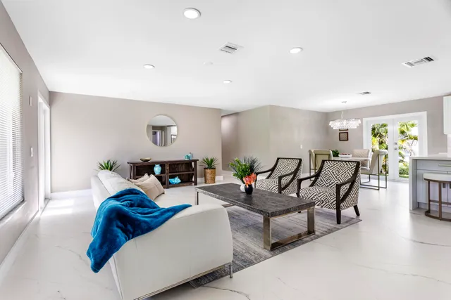 a living room with furniture a window and a table