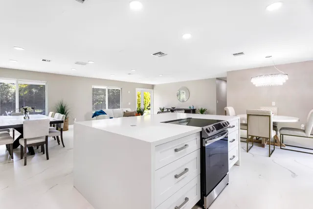 a kitchen with cabinets appliances a sink and a window