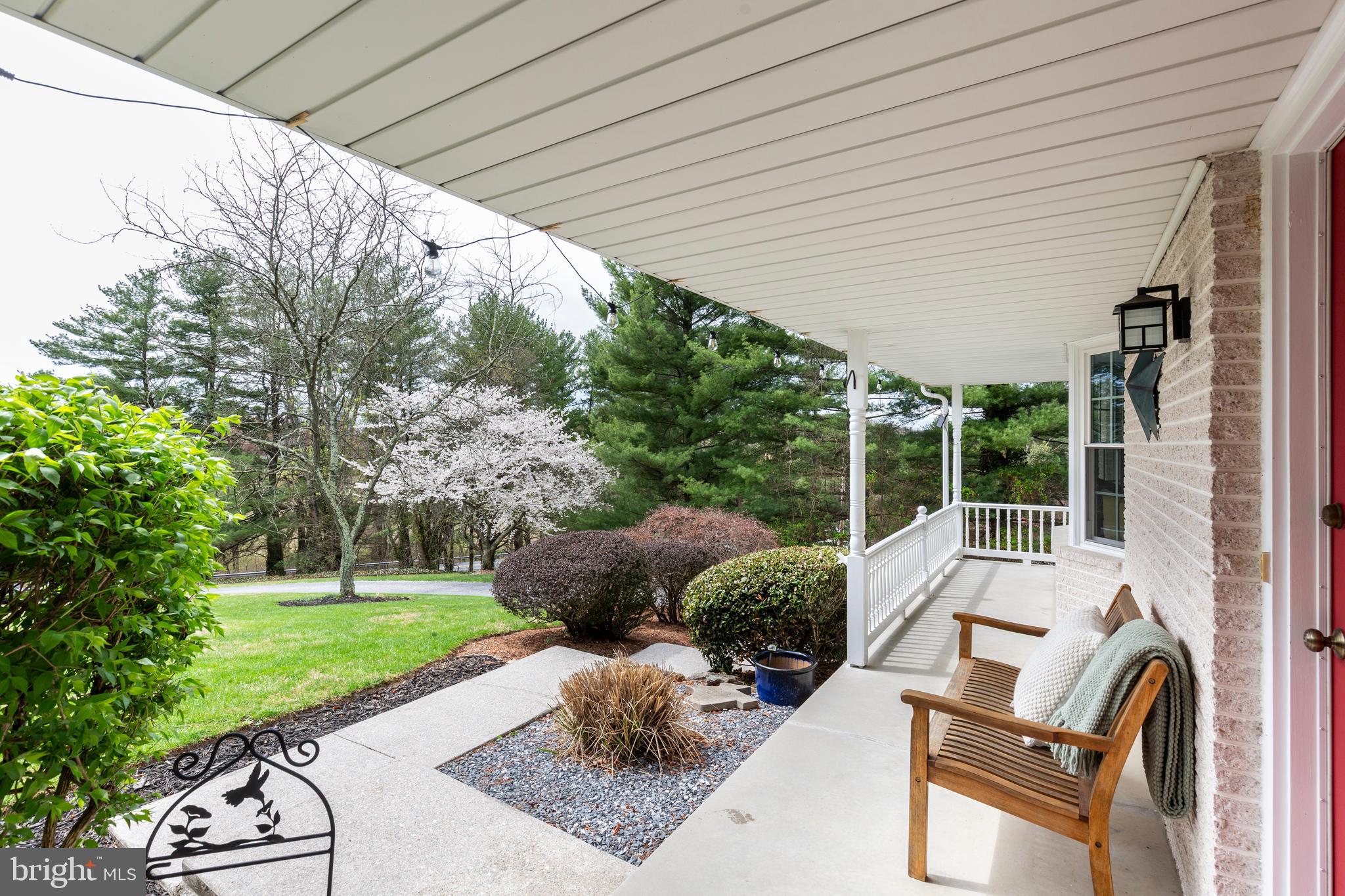 a view of backyard with outdoor seating and green space
