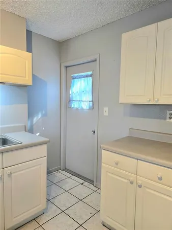 a room with a cabinets and washer dryer